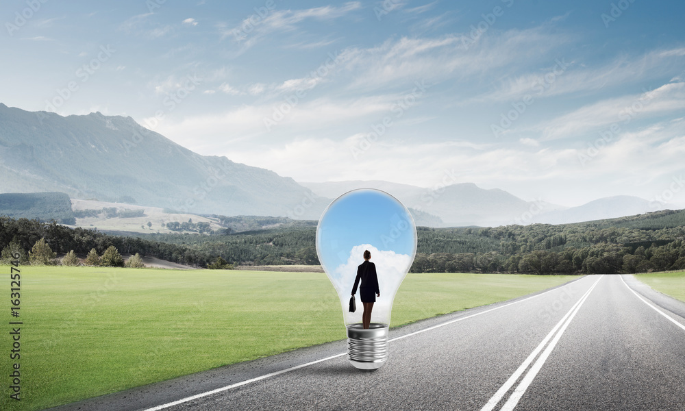 Businesswoman inside light bulb