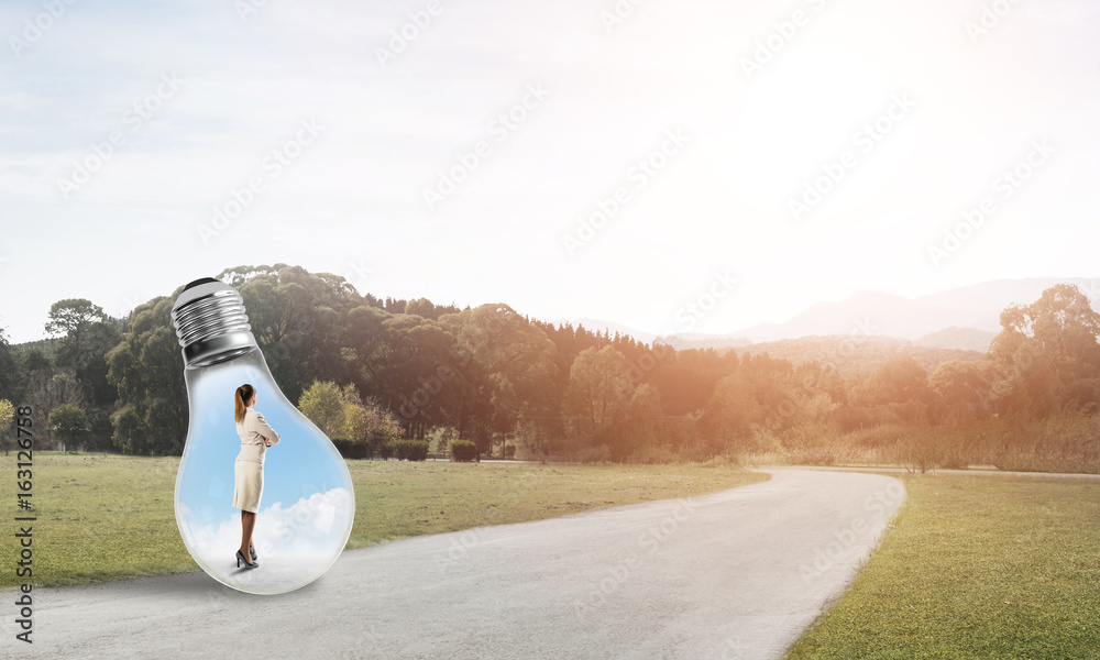 Businesswoman inside light bulb