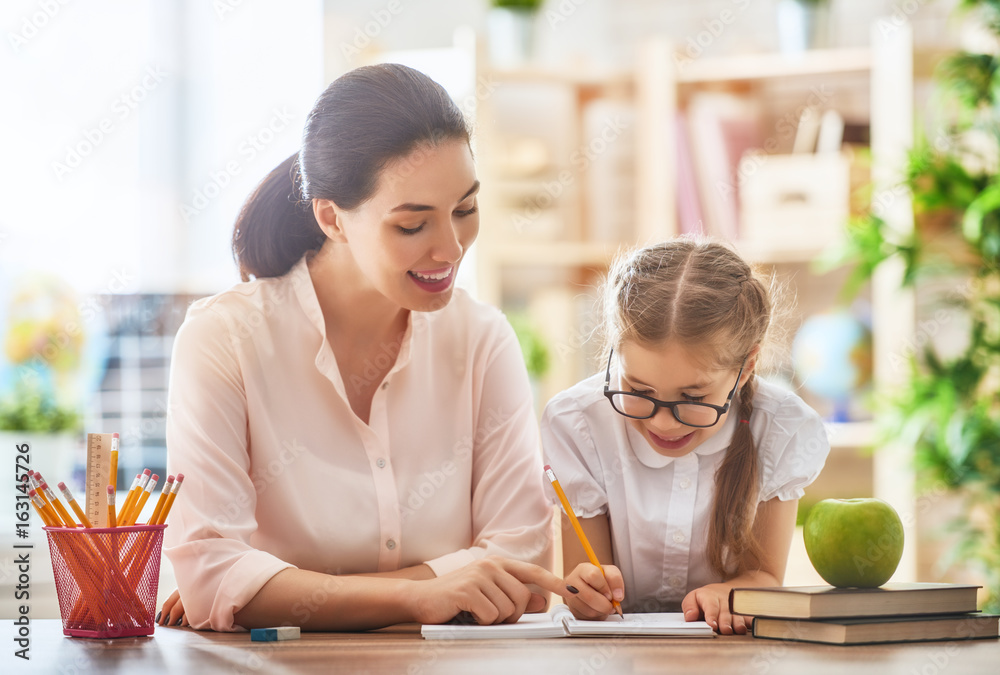 Mother and daughter are learning to write