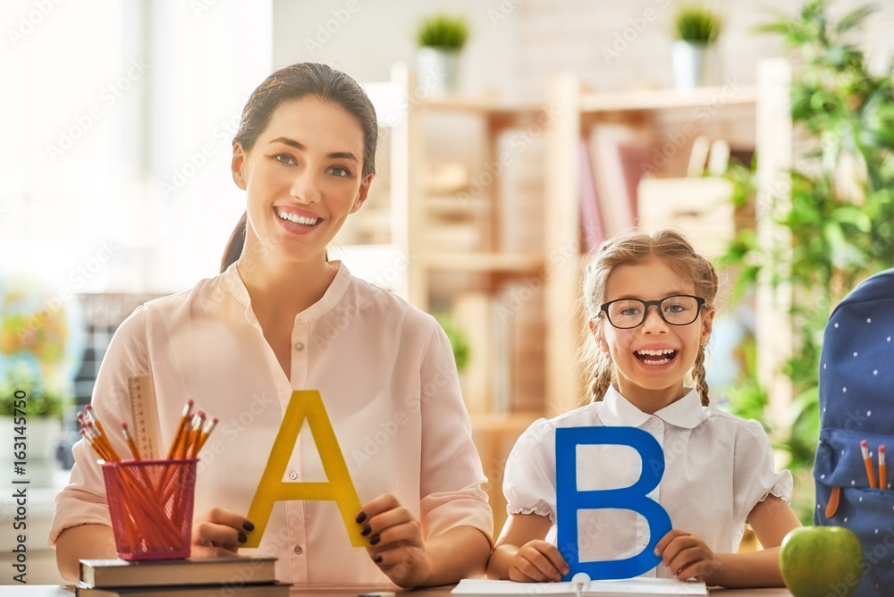 Mother and daughter are learning to write