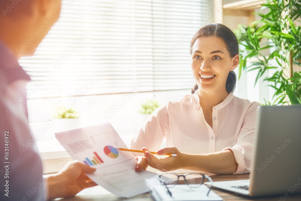 man and woman working in the office