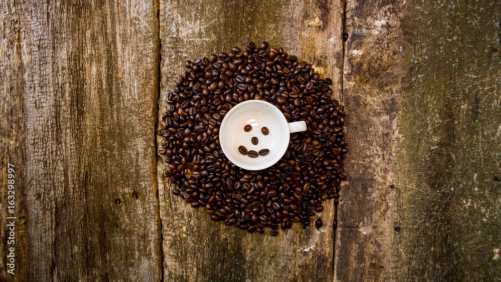 Coffee beans in a white mug. Coffee beans on a wooden background. Dark background.