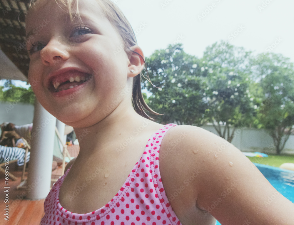 Closeup of caucasian girl standing alone by the pool