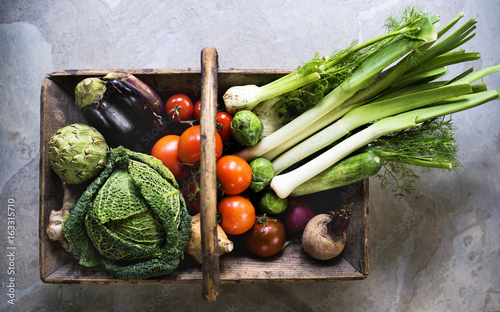 Aerial view of various fresh vegetable in wooden basket