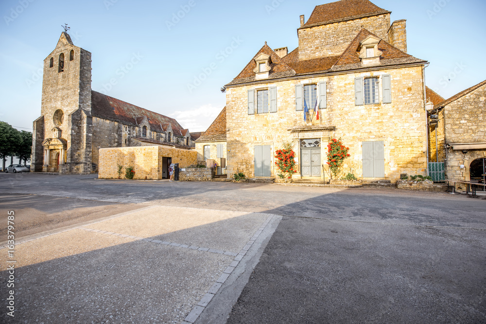 Sunset view on the old church and town hall in Domme village in France