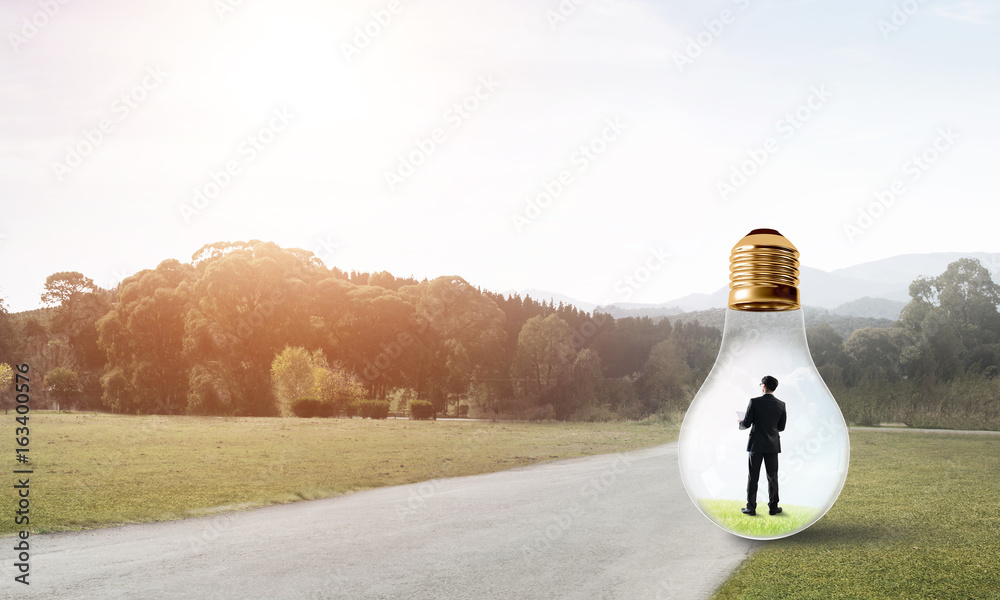 Businessman inside light bulb