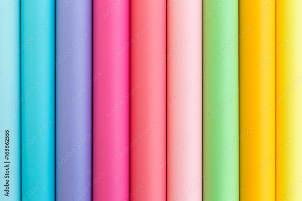 Colorful bright rolls of a paper arranged in a row