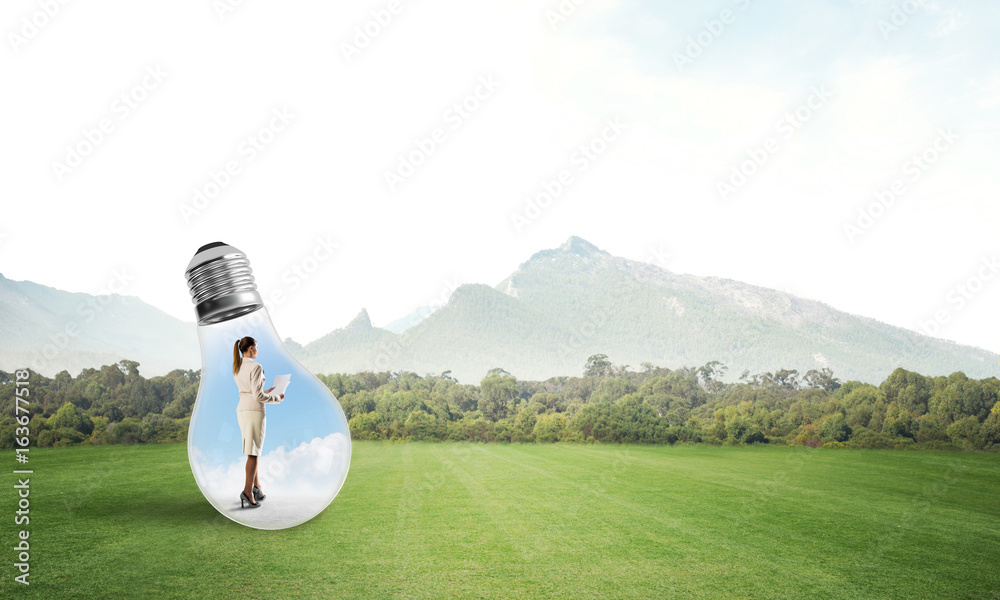 Businesswoman inside light bulb