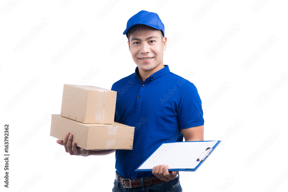 Smiling young asian salesman with parcel and clipboard against a white background