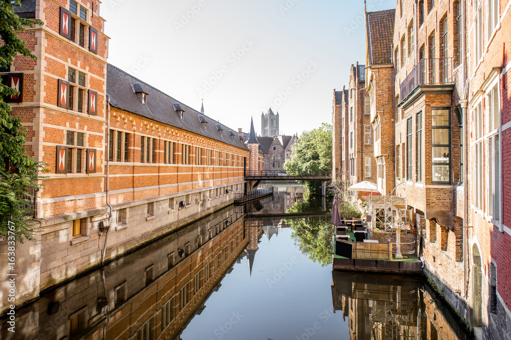 Riverside view with beautiful old buildings and water channel during the morning light in Gent city,