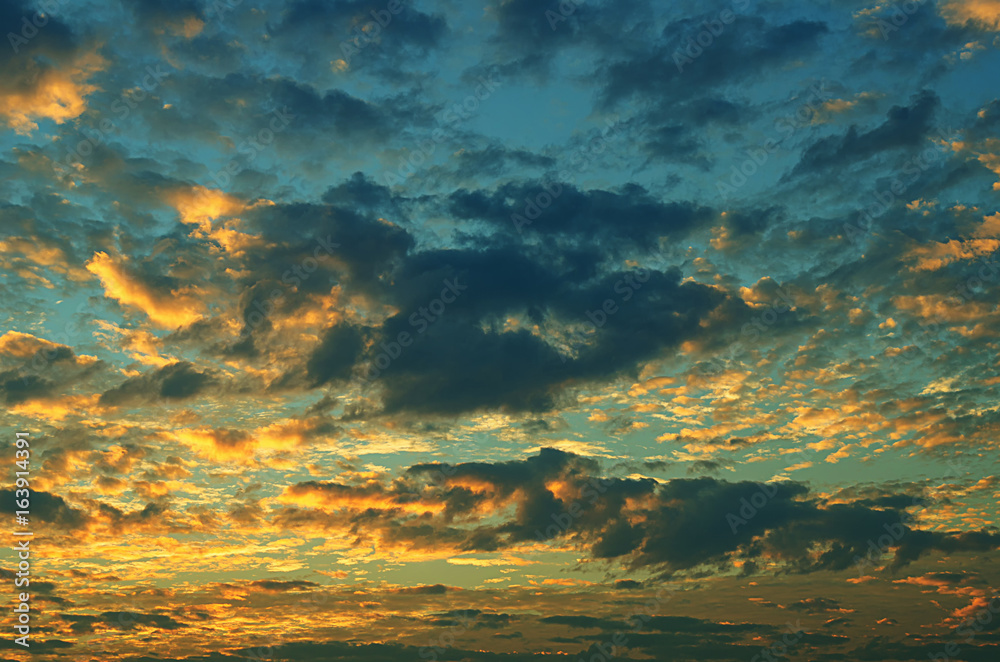 Sunset makes the sky and cloud  a beautiful golden yellow.