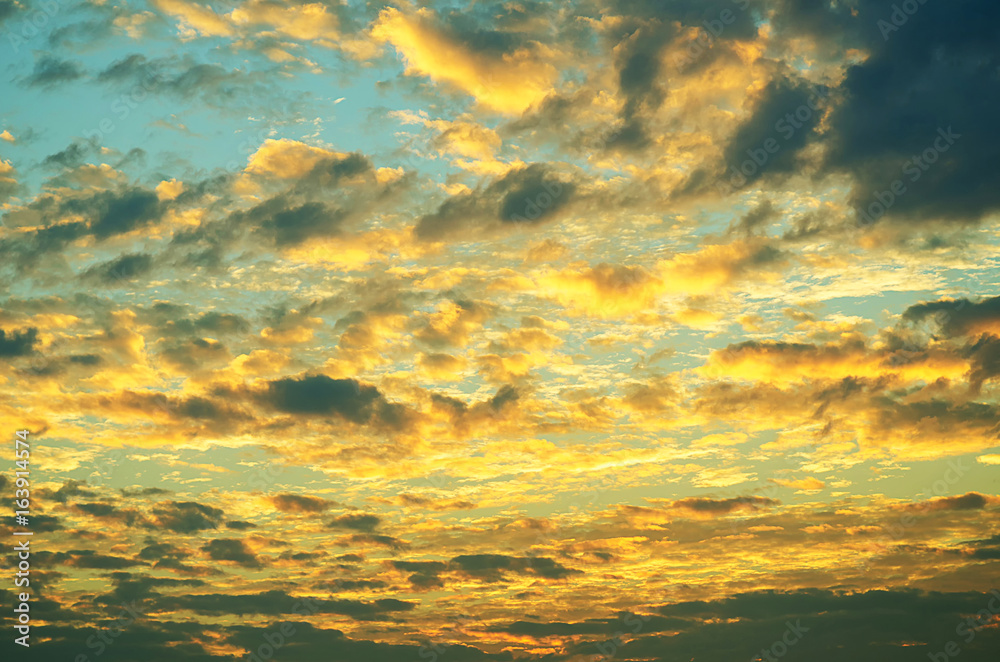 Sunset makes the sky and cloud  a beautiful golden yellow.