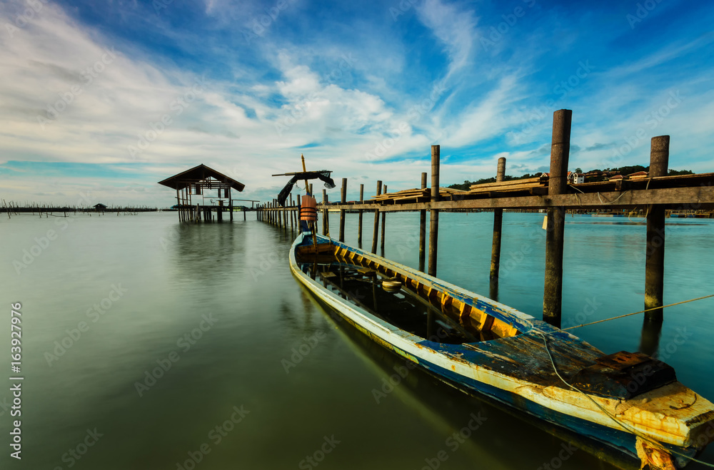 fishing moored at sea. Clouds and light evening twilight and sunset.