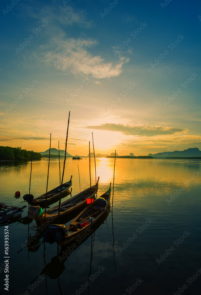 Fishing boats with morning sun on the sea.