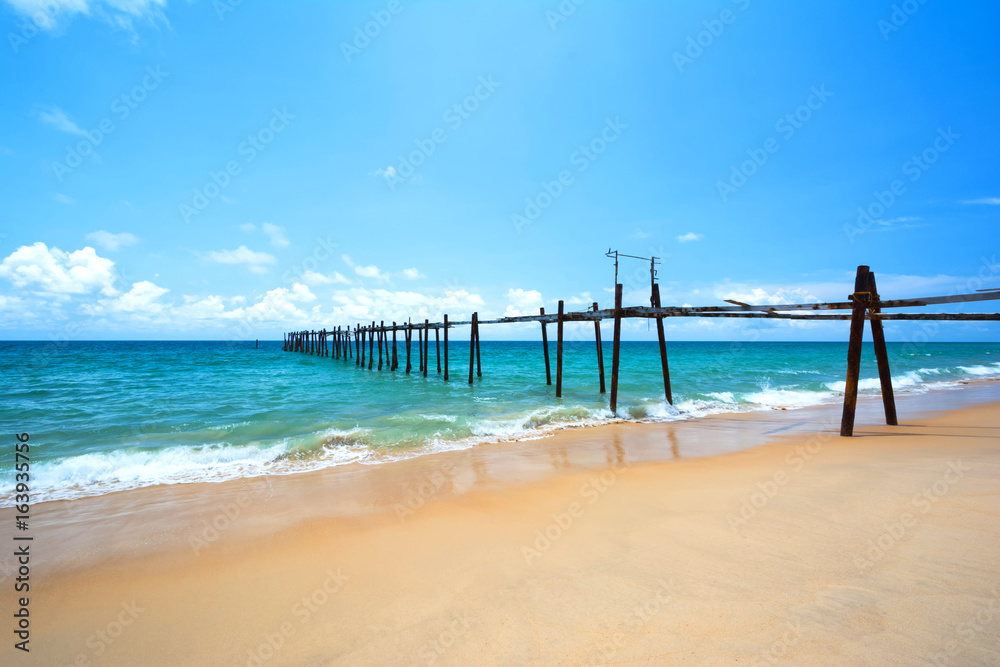 Old bridge in the sea on a clear day in Thailand.