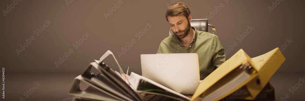 Man working with loads of files and folders pile