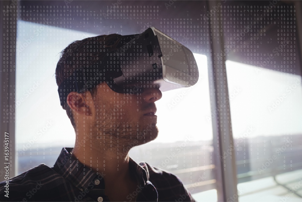 Man in VR headset standing behind interfaces