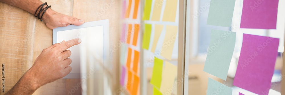 Overhead of hands with tablet and sticky note transition