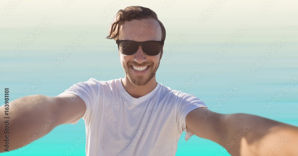 Man taking selfie against light blue background