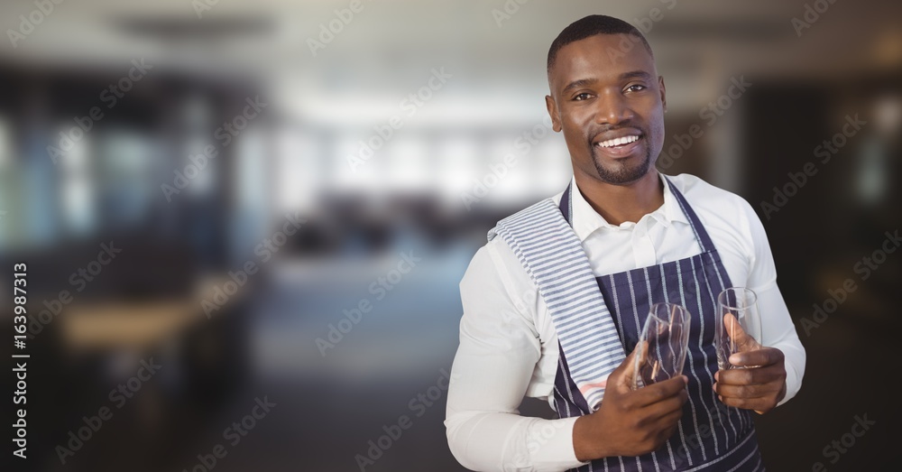 Restaurant owner with glasses against blurry restaurant