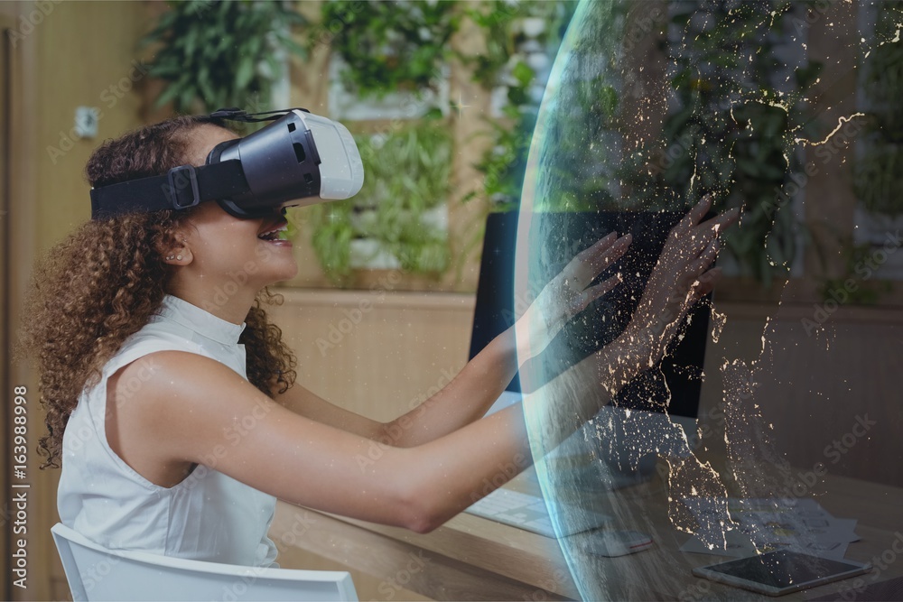 Happy woman in VR headset touching a 3D planet