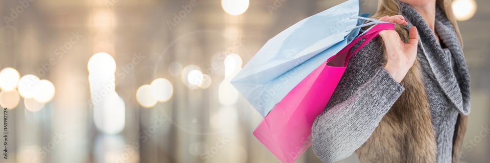 Woman shopping with bags and blurred lights transition