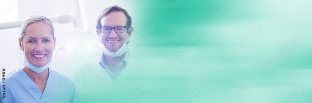 Two dentists smiling and blurry teal transition