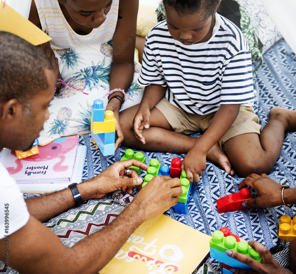 Black family enjoying summer together at backyard