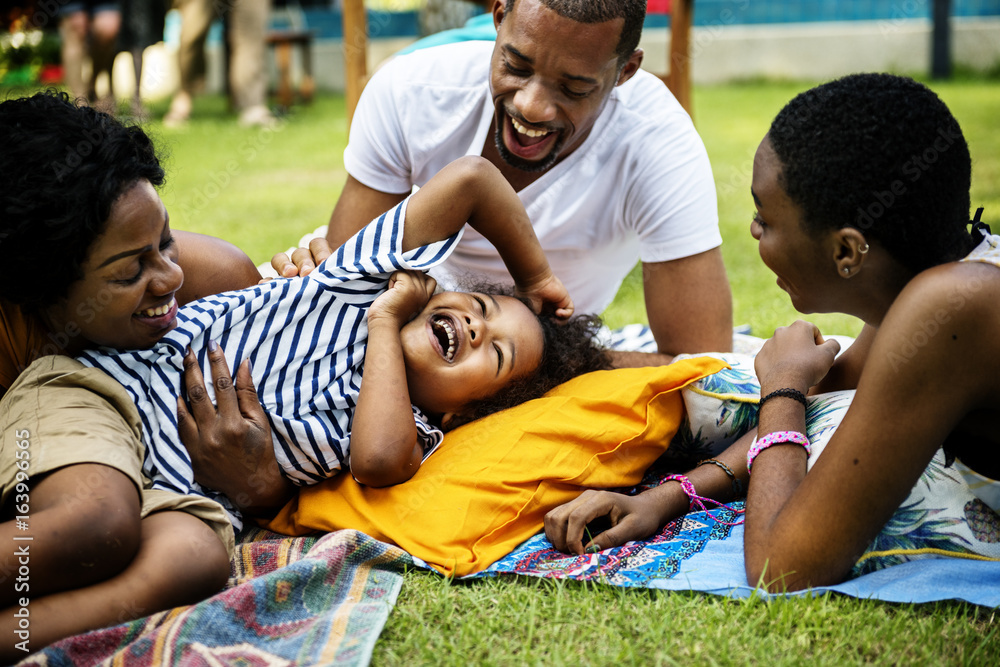 Black family enjoying summer together at backyard