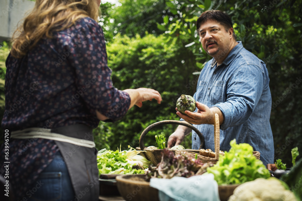 Man buying fresh organic vegetable at market