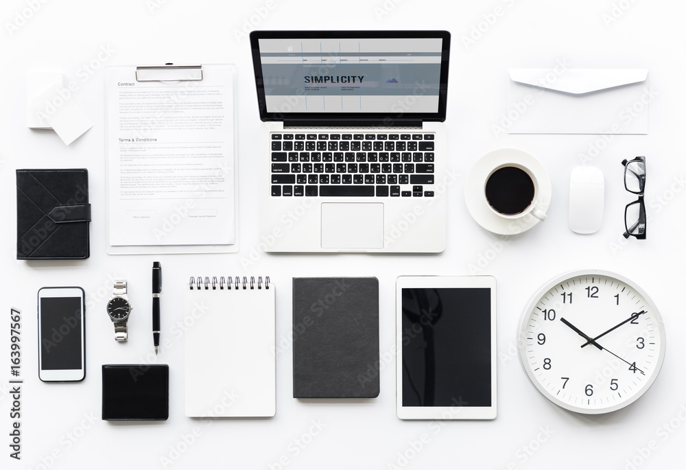 Aerial view of computer laptop with office stationery isolated on white