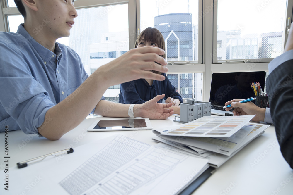 Businessmen are meeting while watching design drawing and color sample