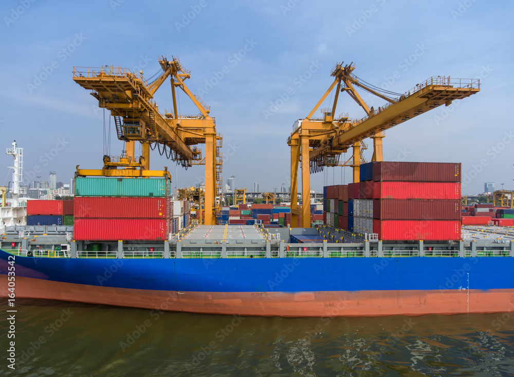 container ship in import export and business logistic.By crane ,Trade Port , Shipping.cargo to harbo