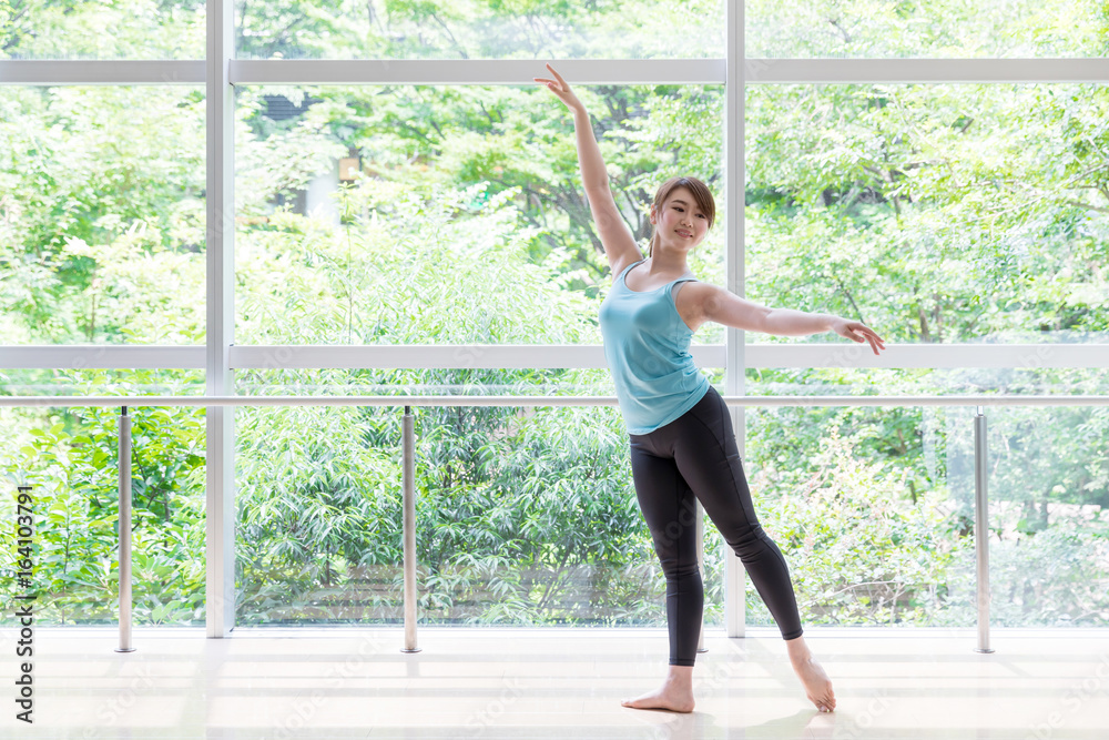 attractive asian woman dancing in studio