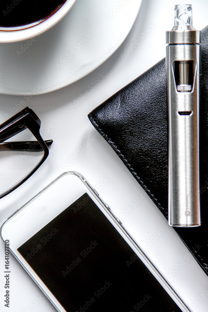 smartphone, electronic cigarette and mens accessories top view