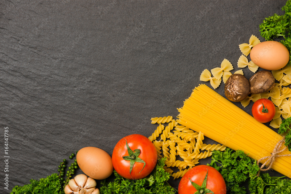 Italian food concept. Pasta ingredients. Cherry-tomatoes, spaghetti pasta, rosemary and spices