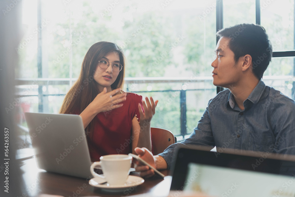 Two people meeting and discuss in coffee shop, freelance work style, outdoor business meeting