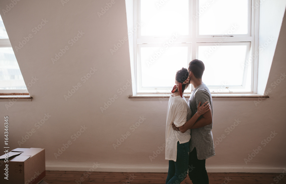 Loving young couple moving in a new apartment