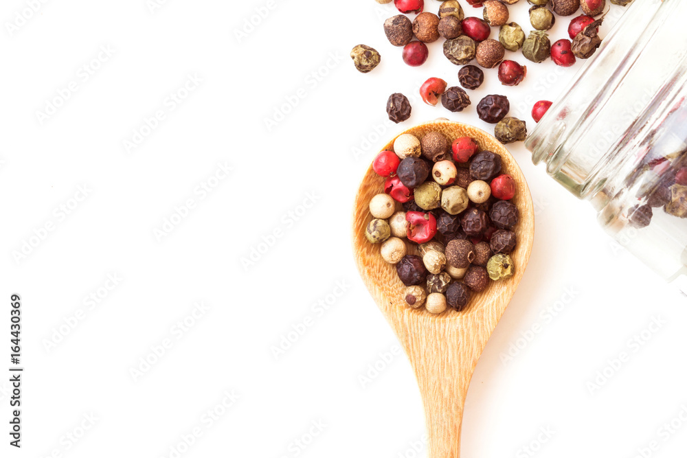 Close up mixed type of the peppercorns in wooden spoon , top view or overhead shot