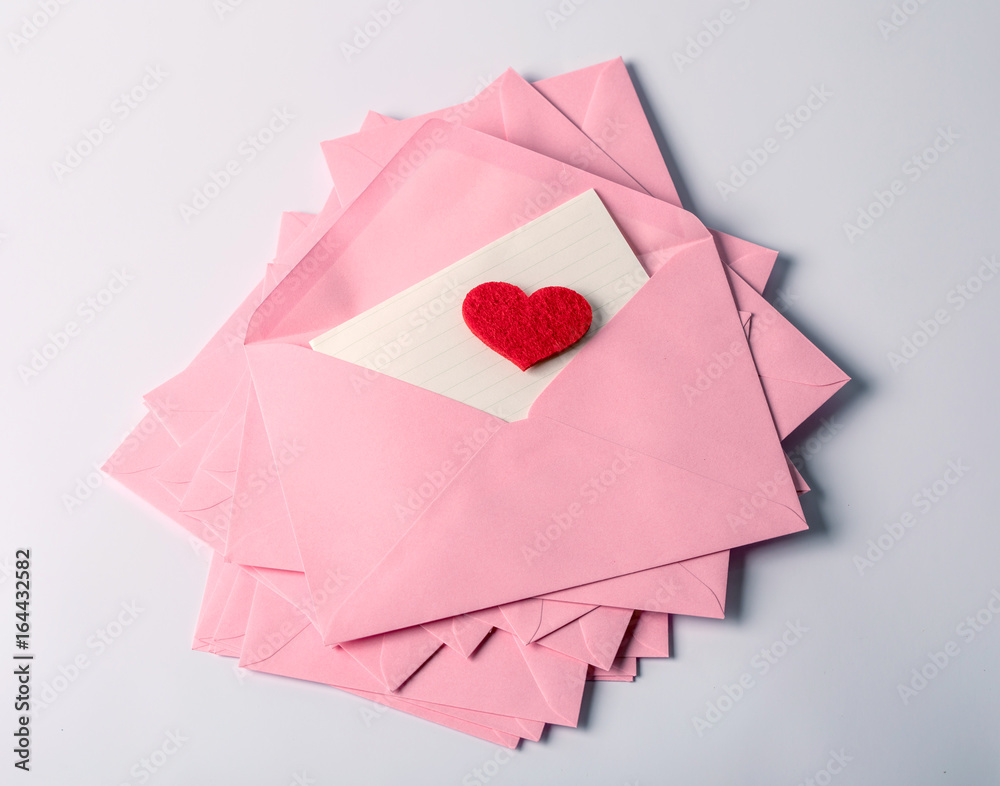 close up Stacking of pink envelopes and mail letter paper and the red herat , romance  love letter c