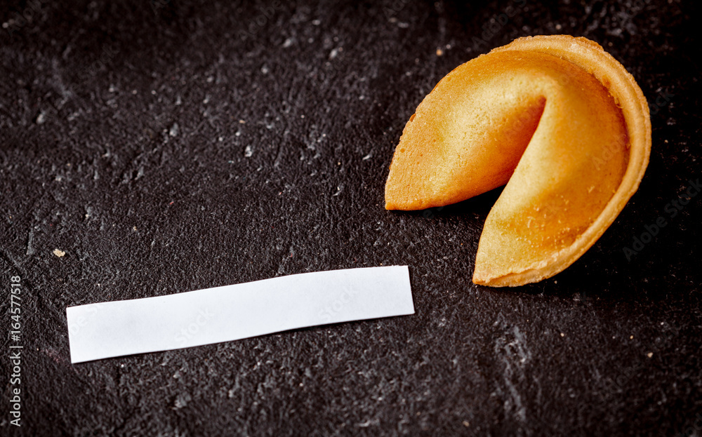 Chinese fortune cookie with prediction on dark background top vi