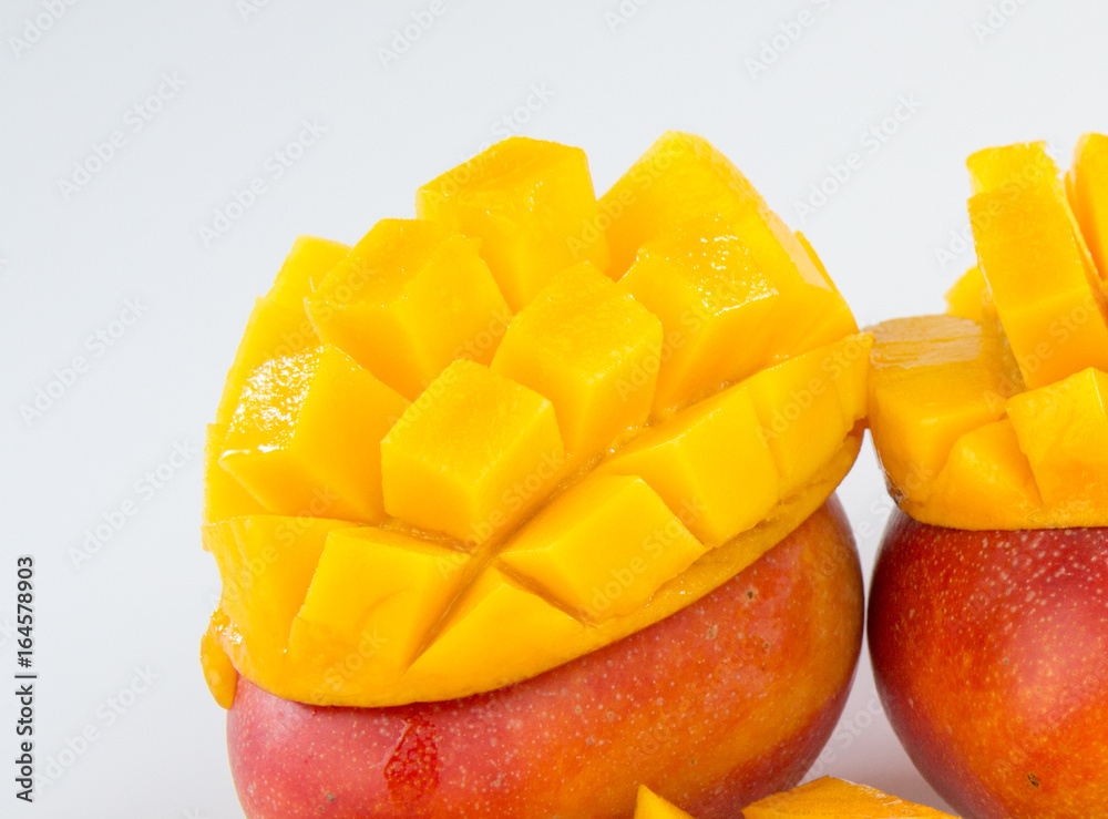 mango fruit and mango cubes in a bamboo basket isolated on white background