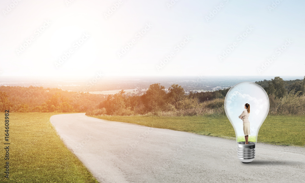 Businesswoman inside light bulb