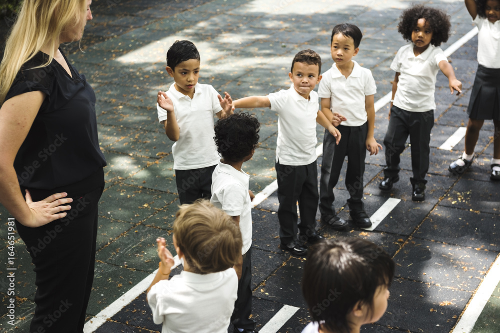 Group of diverse kindergarten students standing together