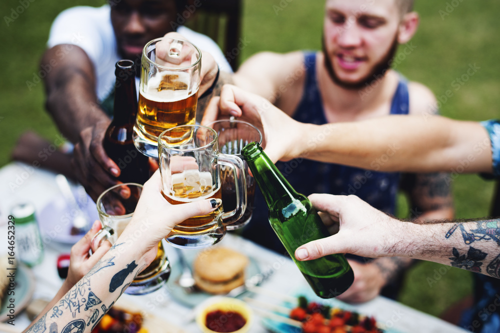 Group of diverse friends celebrating drinking beers together