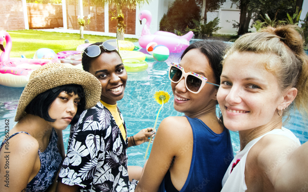 Group of diverse women taking selfie by the pool