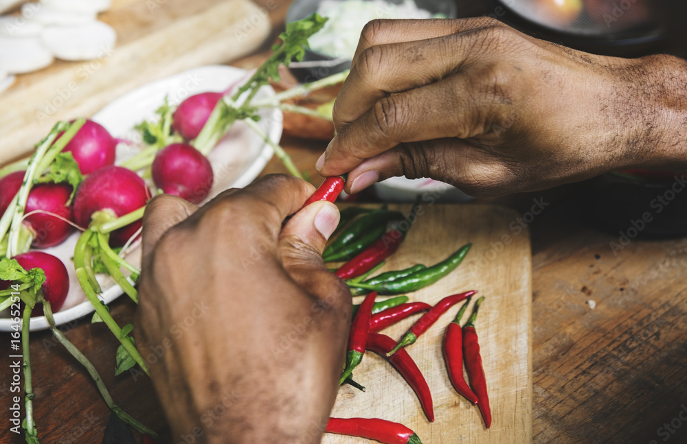 Closeup of hands with chili pepper prepare to cook