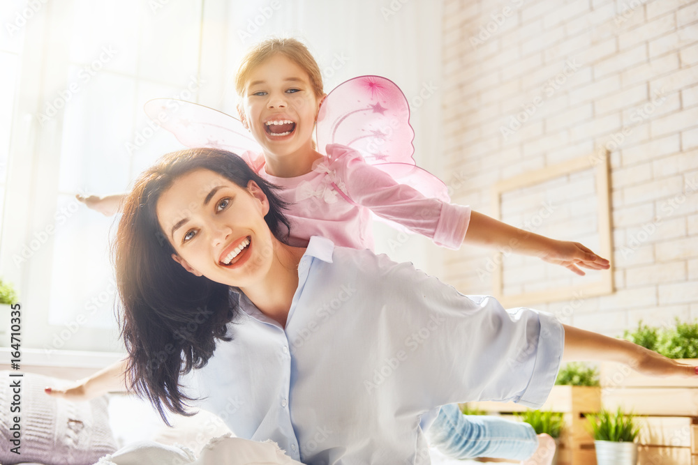 Mother and daughter playing and hugging