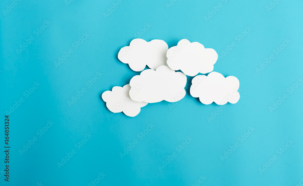 Paper cloud with hard shadow on a blue background