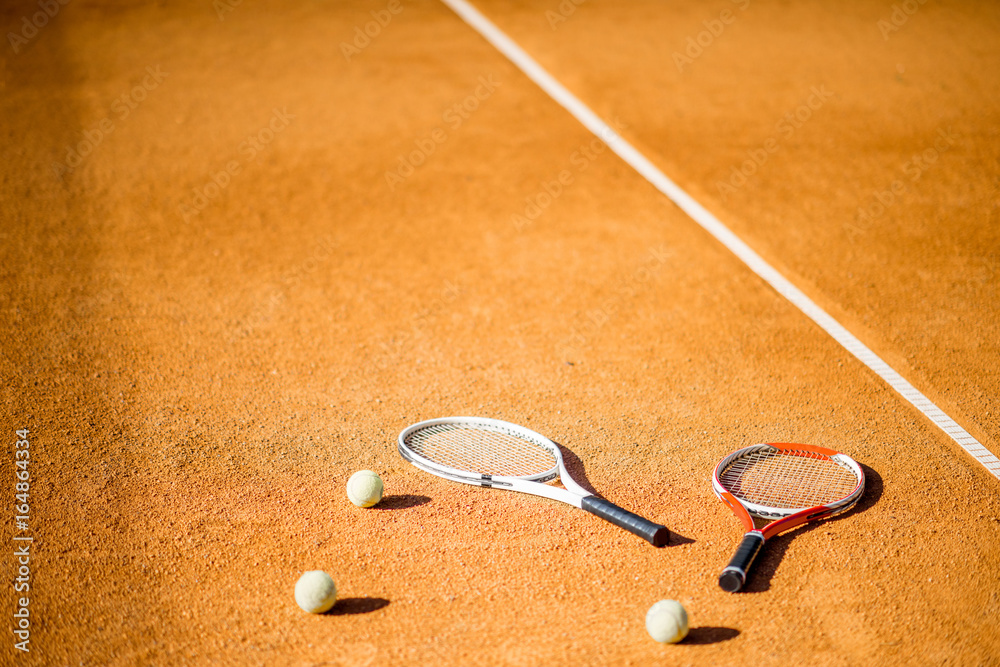 Tennis court with rackets and balls